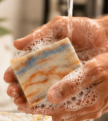 Monkey Farts soap bar lathering under running water