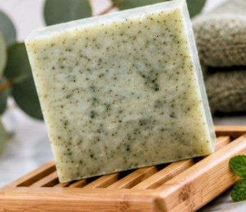 Spearmint eucalyptus soap bar on bamboo dish with eucalyptus leaves
