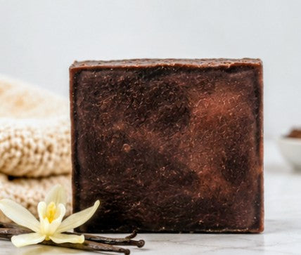 Vanilla soap bar with vanilla bean flower on marble
