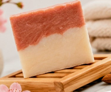 Cherry almond soap bar on bamboo dish with cherry blossoms