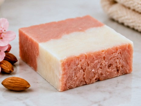 Cherry almond soap bar on marble with almonds and cherry blossoms